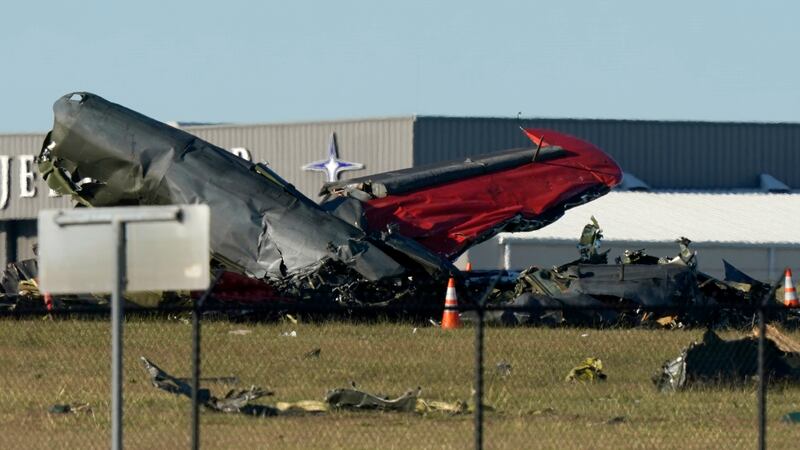 Debris from two planes that crashed during an airshow at Dallas Executive Airport lie on the...