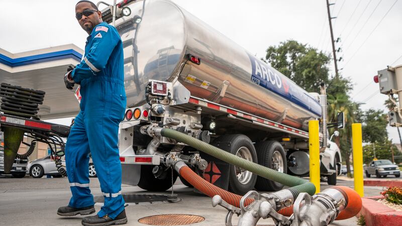 FILE - A driver delivers 8,500 gallons of gasoline at an ARCO gas station in Riverside,...