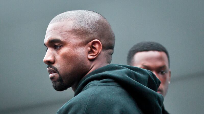 FILE - Kanye West makes final rounds before the showing of the Kanye West Adidas Fall 2015...