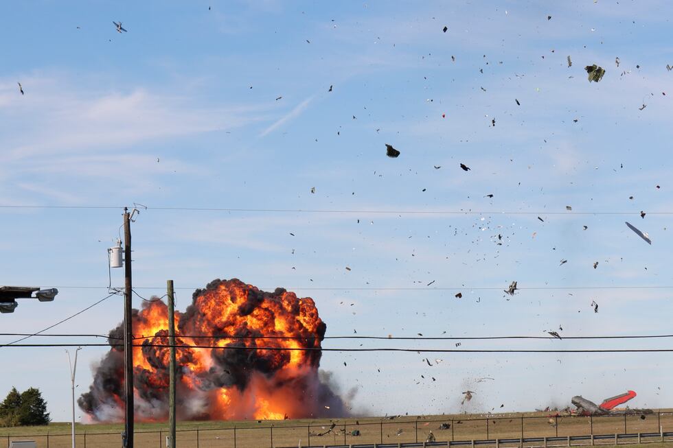 In this photo provided by Nathaniel Ross Photography, a historic military plane crashes after...