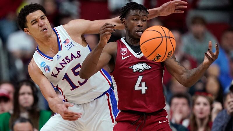 Arkansas guard Davonte Davis (4) is fouled by Kansas guard Kevin McCullar Jr. (15) in the...